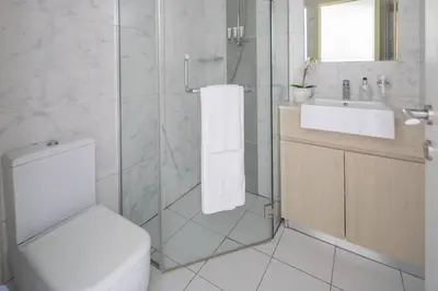 a bathroom with a toilet and a sink and a shower at Frank Porter - Midtown By Deyaar - Dania 2 in Dubai