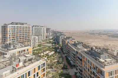 an aerial view of a city with buildings and a beach at Frank Porter - Midtown By Deyaar - Dania 2 in Dubai