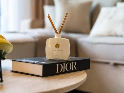 a bottle on top of a book on a table at Contemporary Parkfront 2BR Dubai Hills Living in Dubai