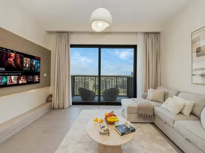 a living room with a couch and a table at Contemporary Parkfront 2BR Dubai Hills Living in Dubai