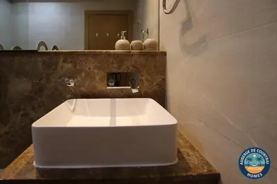 a white sink in a bathroom with a mirror at Modern Studio Fully Furnished Oxford Residence in Dubai