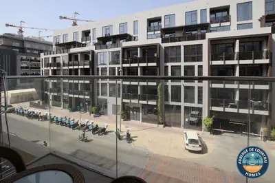 a large building with a parking lot in front of it at Modern Studio Fully Furnished Oxford Residence in Dubai