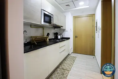 a kitchen with a sink and a counter top at Modern Studio Fully Furnished Oxford Residence in Dubai