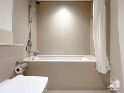 a white bath tub in a bathroom with a toilet at Full Luxury at Burj Crown 2B with City Views in Dubai