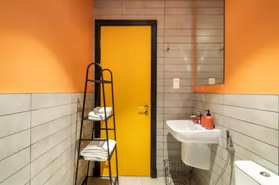 a bathroom with a yellow door and a sink at YouCo Dubai apart-hotel in Dubai