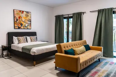 a bedroom with a bed and a couch at YouCo Dubai apart-hotel in Dubai