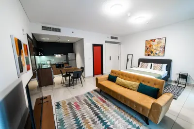 a living room with a couch and a bed at YouCo Dubai apart-hotel in Dubai