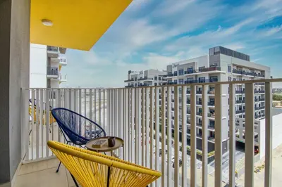 a balcony with a chair and a view of a building at YouCo Dubai apart-hotel in Dubai