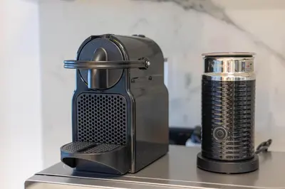 a black blender sitting on top of a counter at New 1BR with Full Balcony Gym Pool and Sauna in Dubai