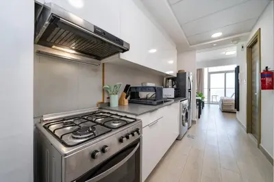 a kitchen with a stainless steel stove top oven at Luxury JVC Studio in a Great Location in Dubai