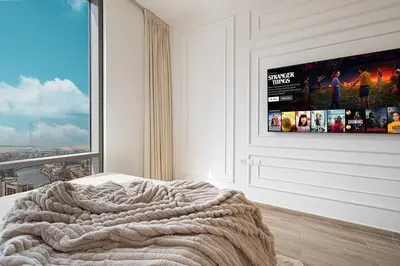 a bedroom with a bed with a large window at 5 Star Amenities 10 Mins Downtown Kite Beach in Dubai