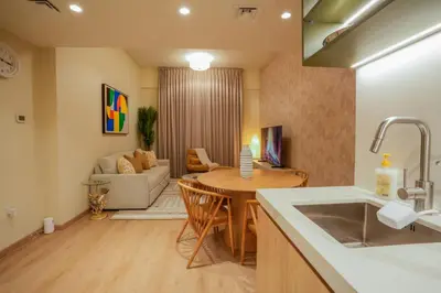 a kitchen and living room with a table and a couch at 2 bedroom Apartment Dubai Marina in Dubai