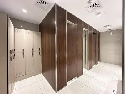 a row of wooden lockers in a locker room at Trophy-Luxe Living in a Blue-Hued Haven in Dubai