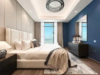 a bedroom with a large bed and blue walls at Trophy-Luxe Living in a Blue-Hued Haven in Dubai