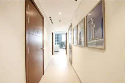 a hallway of a building with paintings on the walls at Livbnb Creekfront 2BR with Skyline Views Steps to Creek Marina in Dubai