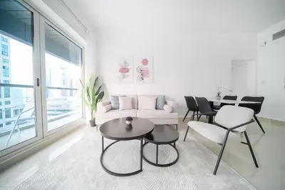 a living room with a couch and chairs and a table at Stella Stays Barsha Heights in Dubai