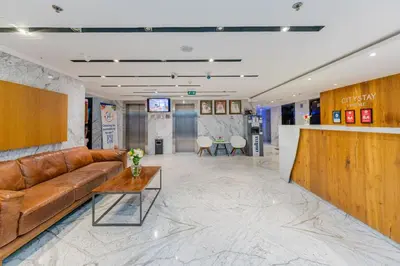 a lobby with a leather couch and a table at City Stay Prime Hotel Apartments - Al Barsha in Dubai