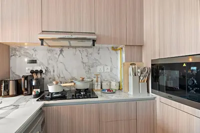 a kitchen with a stove with pots and pans at FIRST CLASS Studio Contemporary Living in JVT in Dubai