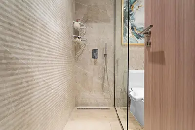 a bathroom with a shower and a toilet in it at FIRST CLASS Studio Contemporary Living in JVT in Dubai