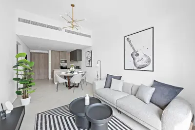 a living room with a couch and a table at Vayk - Modern 2BR with Private Plunge Pool in JVC in Dubai