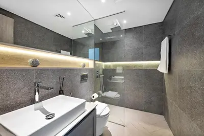 a bathroom with a sink and a toilet at Vayk - Modern 2BR with Private Plunge Pool in JVC in Dubai