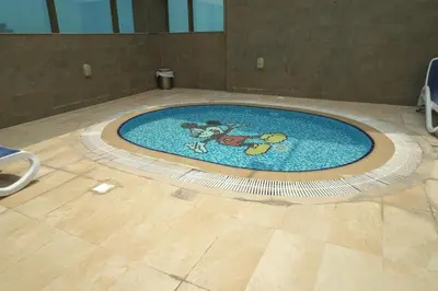a pool with a mickey mouse in the middle of a floor at Stylish 1BR in Elite 7 Sports City in Dubai
