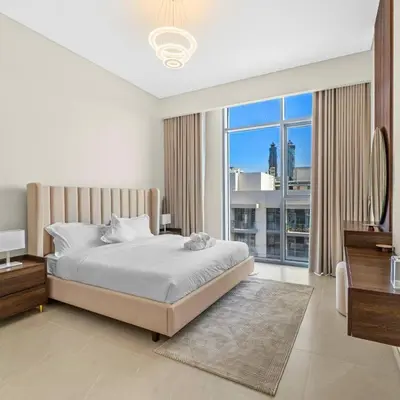 a bedroom with a bed and a large window at Luxury Canal View-2BR Maid's Room in CF 2, Al Wasl in Dubai