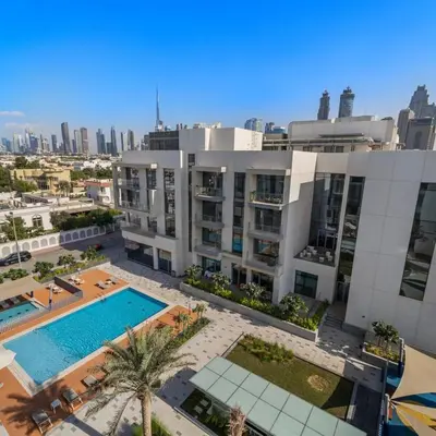 an aerial view of a building with a swimming pool at Luxury Canal View-2BR Maid's Room in CF 2, Al Wasl in Dubai