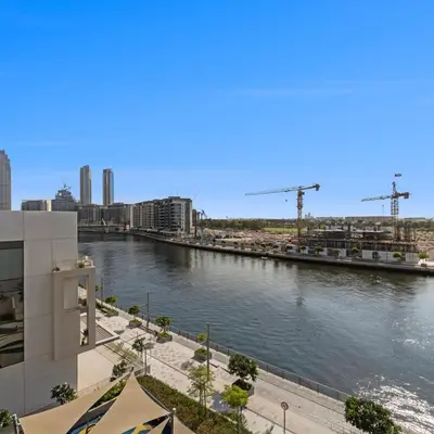 a view of a river with buildings and cranes at Luxury Canal View-2BR Maid's Room in CF 2, Al Wasl in Dubai