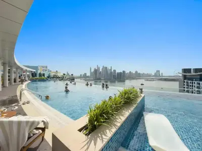 a pool on the top of a building with people in it at FIRST CLASS Studio Palm Paradise in Dubai