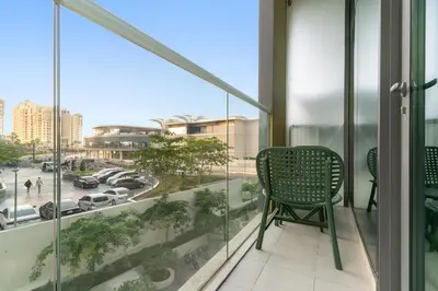 a balcony with a chair and a view of a city at FIRST CLASS Studio Palm Paradise in Dubai