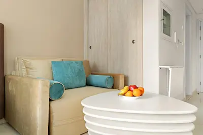 a living room with a couch and a table with fruit on it at FIRST CLASS Studio Palm Paradise in Dubai