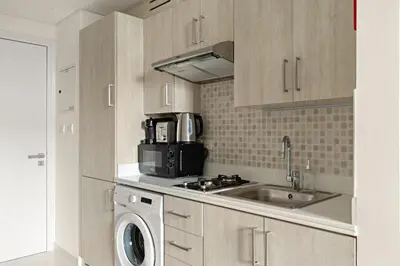 a kitchen with a sink and a washing machine at FIRST CLASS Studio Palm Paradise in Dubai