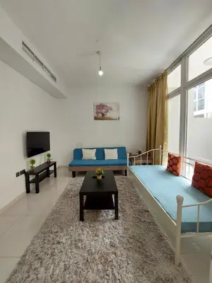 a living room with two beds and a tv at Damac Hills 2- 3BR Townhouse - Homeyvillas in Dubai