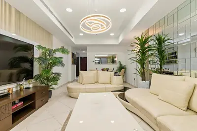 a living room with two couches and a table at Luxury 2BR with City Skyline Views Steps to JBR Beach & Marina Mall in Dubai