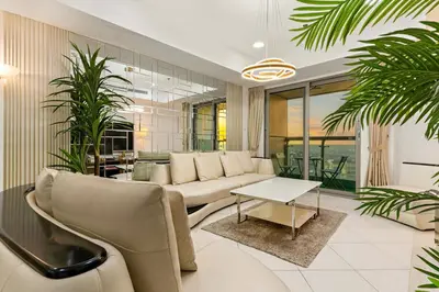 a living room with a couch and a table at Luxury 2BR with City Skyline Views Steps to JBR Beach & Marina Mall in Dubai