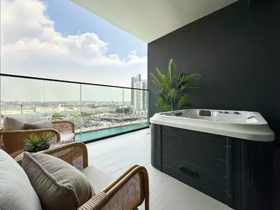 a bathroom with a bath tub and a large window at Luxe Living in the Heart of Bbay w Jacuzzi in Dubai