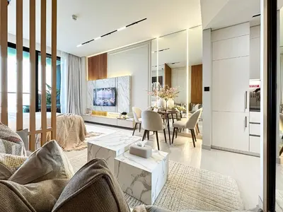 a living room with a table and a kitchen at Luxe Living in the Heart of Bbay w Jacuzzi in Dubai