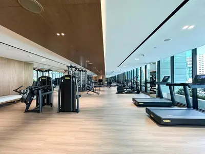 a gym with cardio equipment in a building at Luxe Living in the Heart of Bbay w Jacuzzi in Dubai