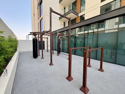 a row of metal bars on the side of a building at Stylish Studio in JVC with Pool, Gym, Balcony & Modern Comforts in Dubai