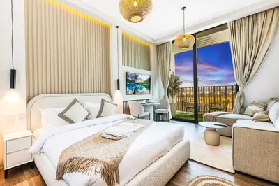 a bedroom with a bed and a living room at FIRST CLASS Studio Unwind in Style in Dubai