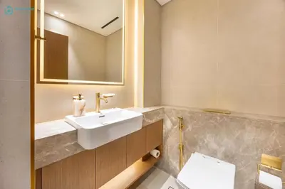 a bathroom with a sink and a toilet at Blue Breeze - Luxurious 1BR with Private Jacuzzi & Burj View in Dubai