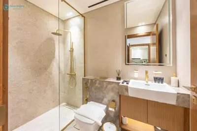 a bathroom with a toilet and a sink and a shower at Blue Breeze - Luxurious 1BR with Private Jacuzzi & Burj View in Dubai