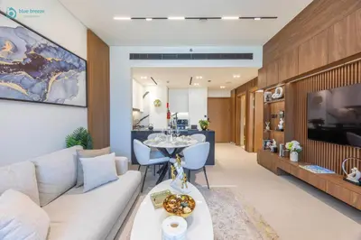 a living room with a couch and a table at Blue Breeze - Luxurious 1BR with Private Jacuzzi & Burj View in Dubai