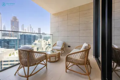 a balcony with chairs and a view of the city at Blue Breeze - Luxurious 1BR with Private Jacuzzi & Burj View in Dubai