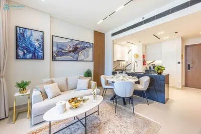 a living room with a couch and a table at Blue Breeze - Luxurious 1BR with Private Jacuzzi & Burj View in Dubai