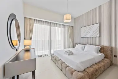 a bedroom with a large bed and a mirror at Act tower-1BR near Burj Khalifa in Dubai