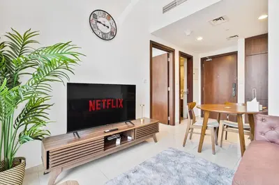 a living room with a flat screen tv on a wall at Modern 1 Bed with Burj View From Balcony & Pool and Gym Access in Dubai