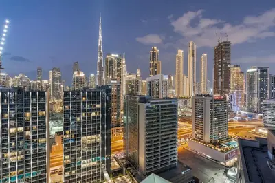a view of a large city at night at Modern 1 Bed with Burj View From Balcony & Pool and Gym Access in Dubai