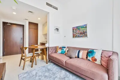 a living room with a couch and a table at Modern 1 Bed with Burj View From Balcony & Pool and Gym Access in Dubai